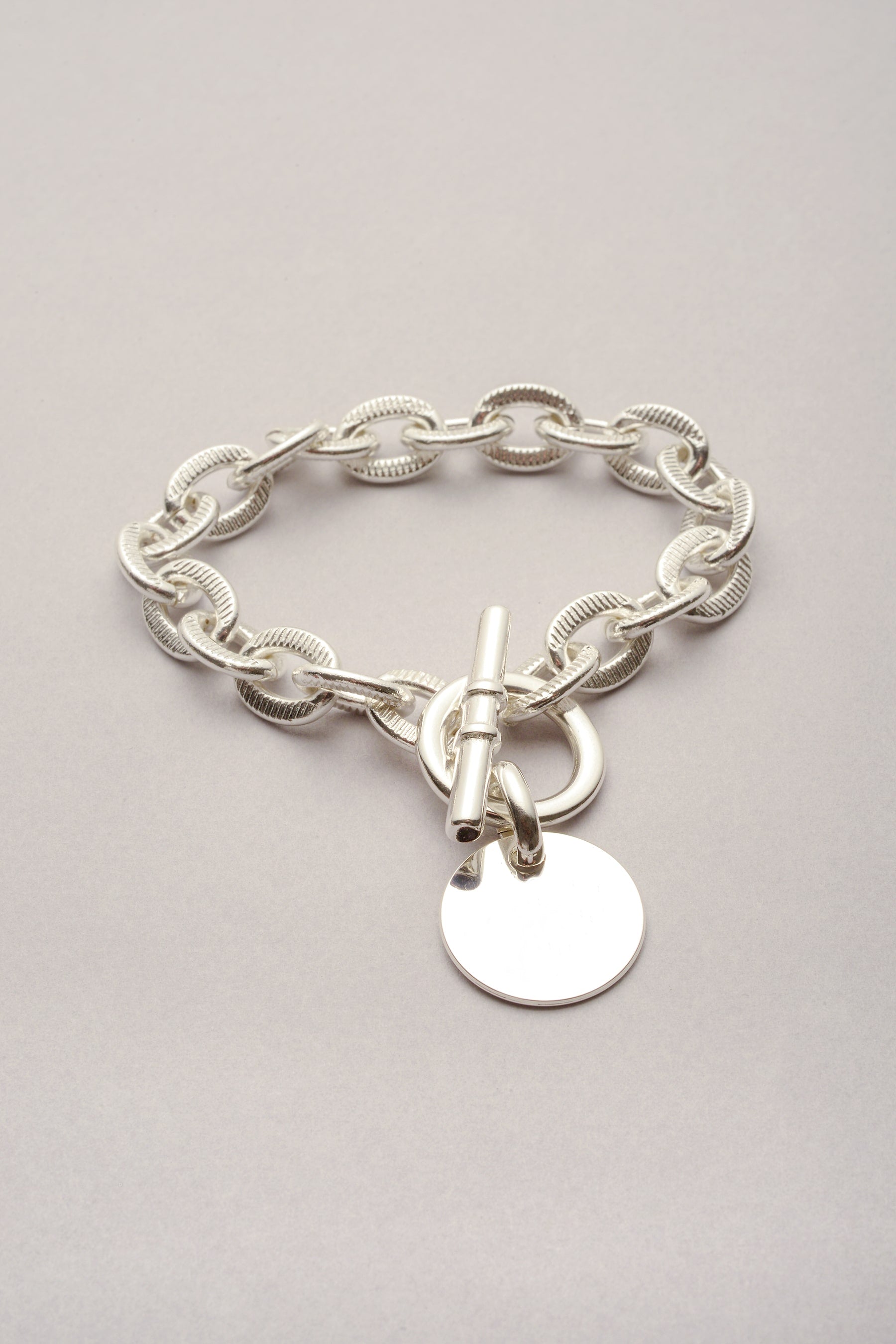 Bracelet Scarlett Médaille avec chaîne argenté. Bijou artisanal fabriqué en France pour femme. Ce bracelet est composé d'un fermoir en T et d'une médaille classique. 