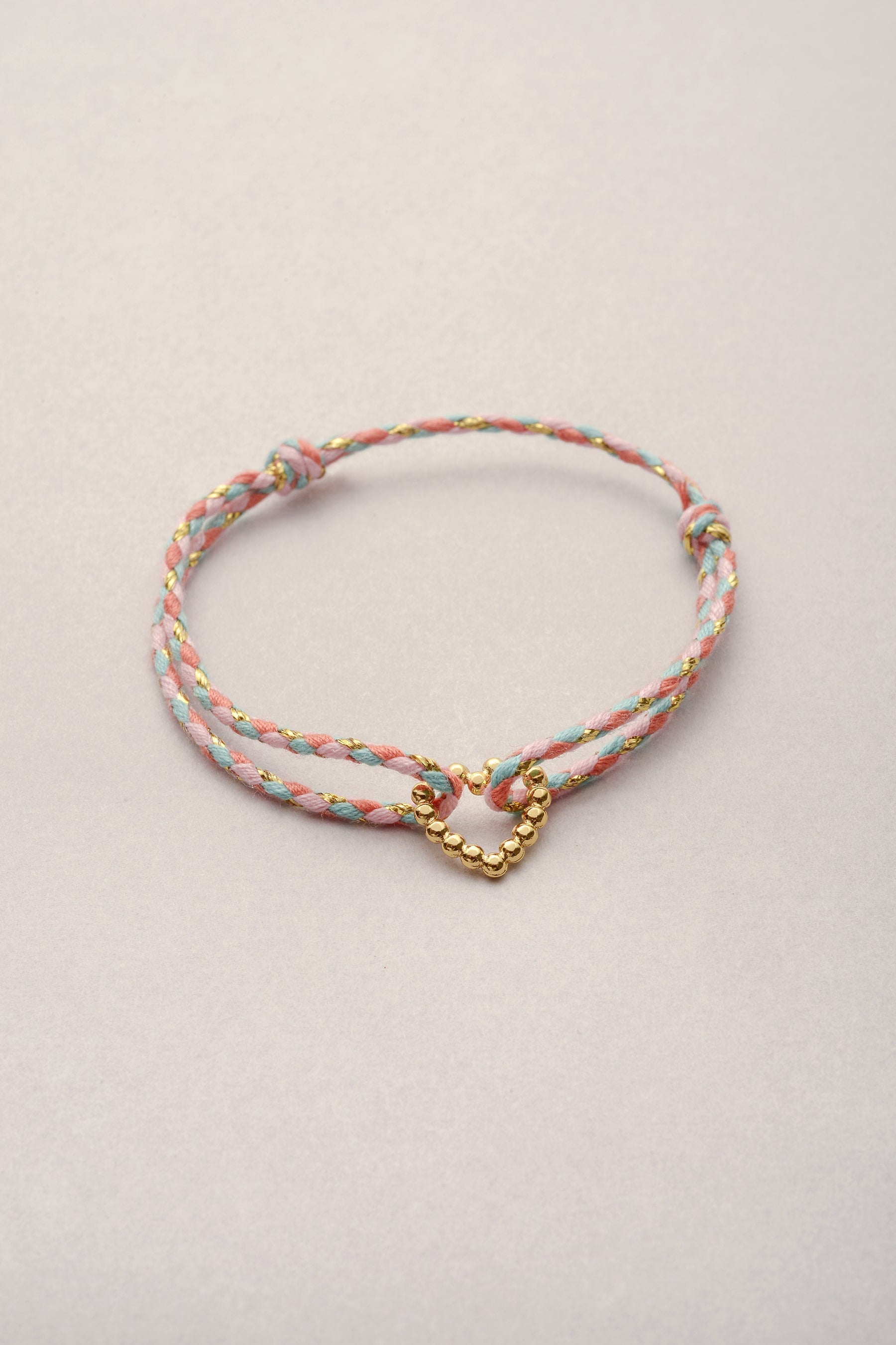Bracelet petit cœur doré Musardise, bijou fantaisie français sur cordon tressé coloré personnalisable avec cœur doré à l’or fin, assemblé à la main à Toulouse.