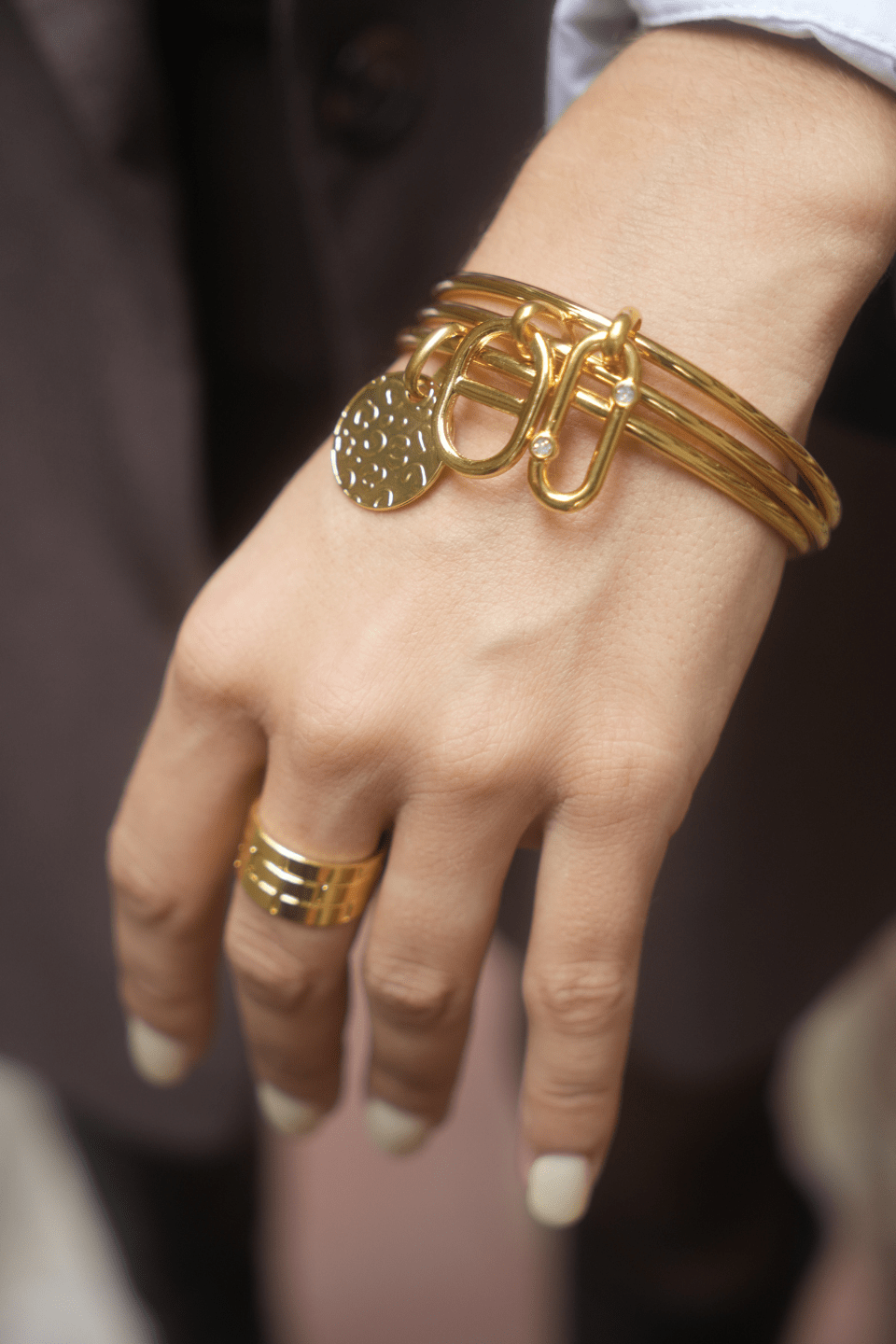 Photo de joncs dorés avec des breloques. Bijoux pour femme fabriqués en France. Joncs pour enfant et adulte. 