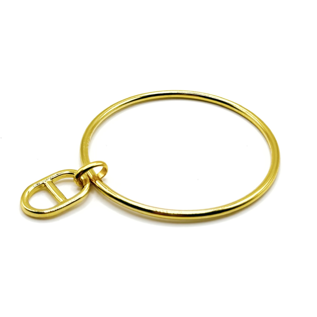 Jonc doré avec une jolie pampille maille marine dorée